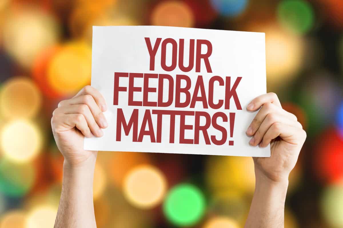 Your feedback matters man holding up sign